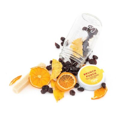 A jar of dried fruit and orange slices on top of the table.