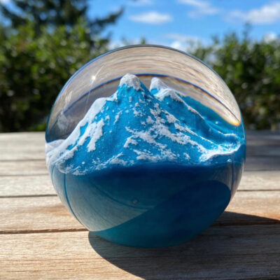 A glass ball with a mountain inside of it