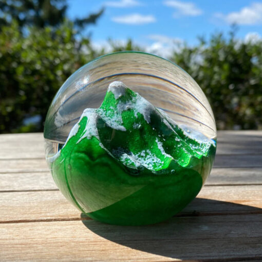 A green ball with some water inside of it