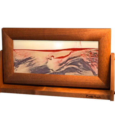 A picture of the ocean in a wooden frame.